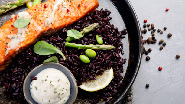 istock Baked salmon with asparagus and black rice. 1365532792