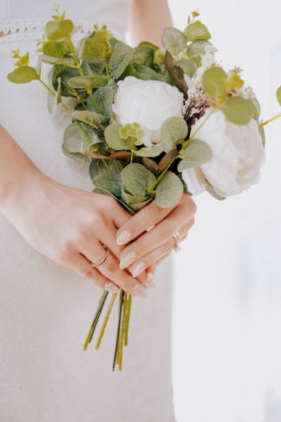 istock Beautiful bouquet in hands of the bride 1365533190