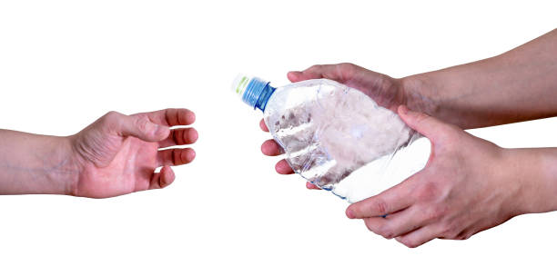 istock A man passes an empty, plastic bottle, isolated on a white background. 1365533545