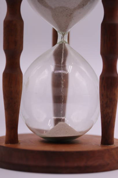 istock Hourglass pouring sand counting time 1365534648