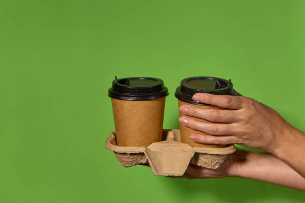 istock women's hands hold two paper cups 1365536176