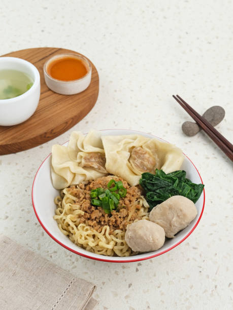 Mie ayam (noodles with chicken, meatballs, dumplings and vegetables) is a popular street food in Indonesia.
