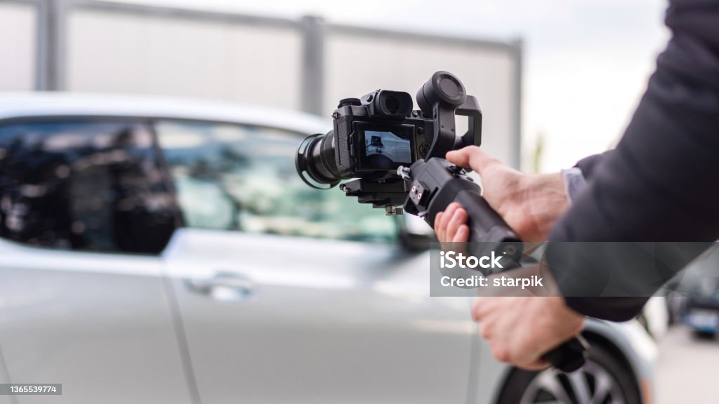 BMW i3 shooting Camera man with stabilizer shooting parked BMW i3 Showroom Stock Photo
