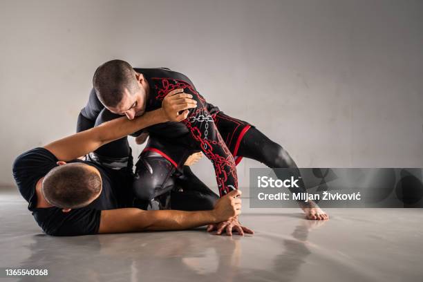 Brazilian Jiu Jistu Bjj Nogi Grappling Training Two Male Athletes Drilling Technique Or Sparring At Gym Academy Guard Position Stock Photo - Download Image Now