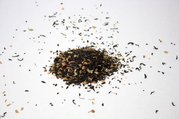 istock Pile of black leaf tea on a white background. Isolated, top view. 1365540502