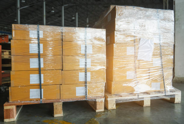 istock Packaging Boxes Wrapped Plastic Film in Storage Warehouse. Supply Chain. Storehouse Commerce Shipment. Warehouse Shipping Logistics. 1365541132