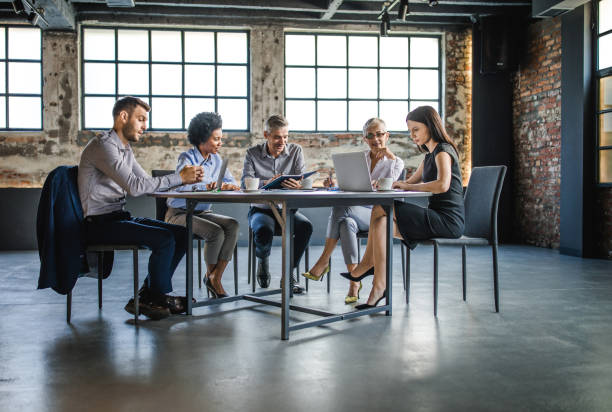 istock Multi-tasking business people working on a meeting in the office. 1365541308