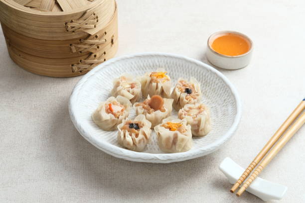 istock Mini Dim Sum chinese dumplings served on white plate 1365542527