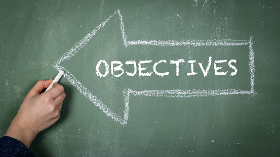 Objectives. Directional arrow drawn on a chalkboard.