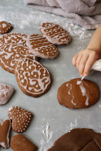 Girl makes homemade gingerbread cookies for Easter