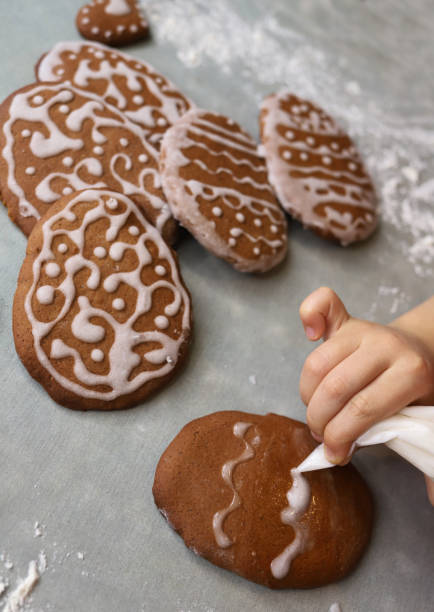 Girl decorates homemade gingerbread for Easter