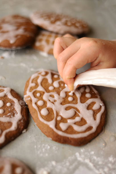 Girl decorates homemade gingerbread for Easter