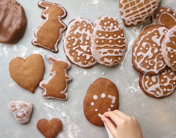 Girl makes homemade gingerbread cookies for Easter