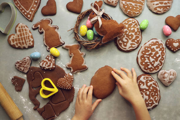 Girl decorates homemade gingerbread for Easter