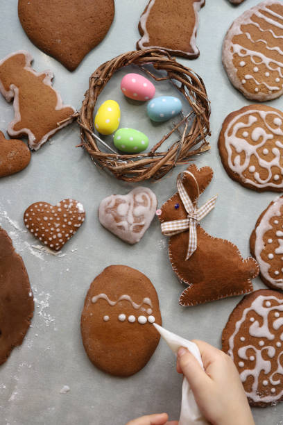 Girl makes homemade gingerbread cookies for Easter