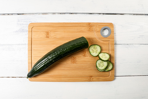 Sliced cucumber on a cutting board. Fresh products and vitamins.