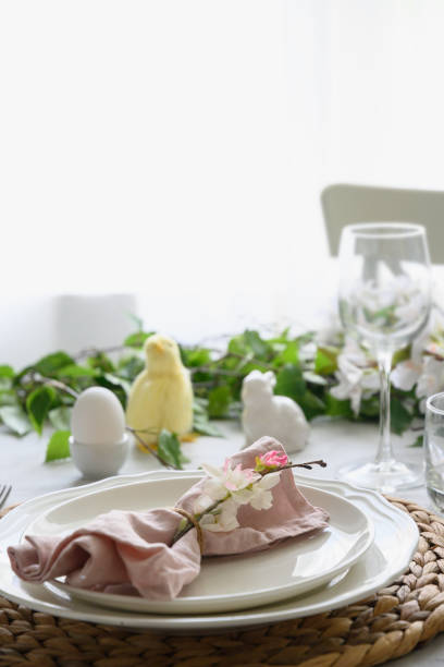 istock Easter table setting with yellow chick, fresh flowers and eggs. Close up. 1365546954