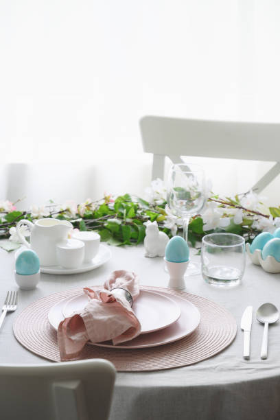 istock Easter table setting with yellow chick, fresh flowers and eggs. Close up. 1365546964