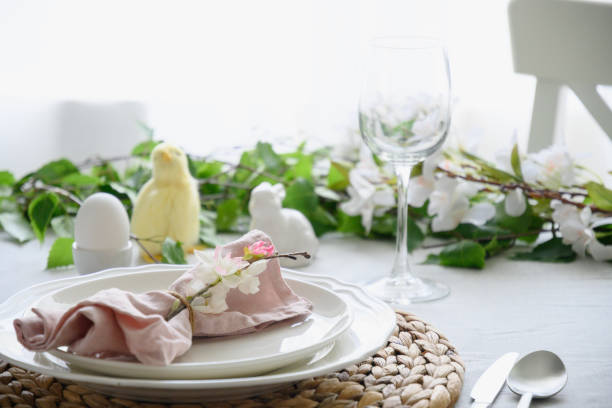 istock Easter table setting with yellow chick,decorations, fresh flowers and eggs. Elegance dinner at home. 1365546969