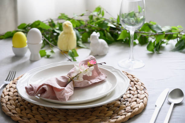 istock Easter table setting with yellow chick,decorations, fresh flowers and eggs. Elegance dinner at home. 1365546972