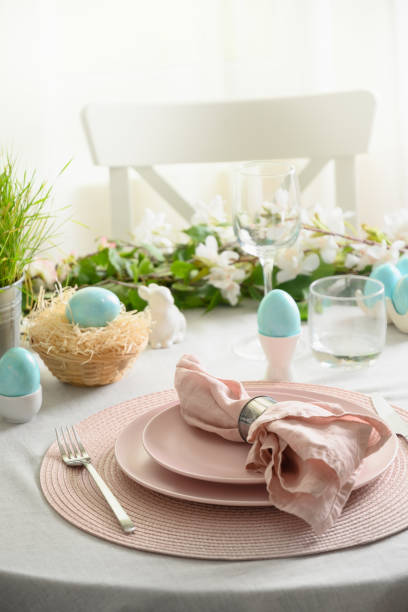 istock Easter table setting with yellow chick, fresh flowers and eggs. Close up. 1365546973