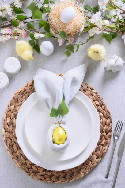 istock Easter table setting with yellow chick,decorations, fresh flowers and eggs. Elegance dinner at home. Close up. 1365546976