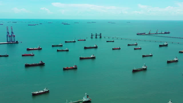 Aerial view  Oil Ship tanker parking on the sea waiting for load or unload oil at loading dock from refinery for transportation on the sea.