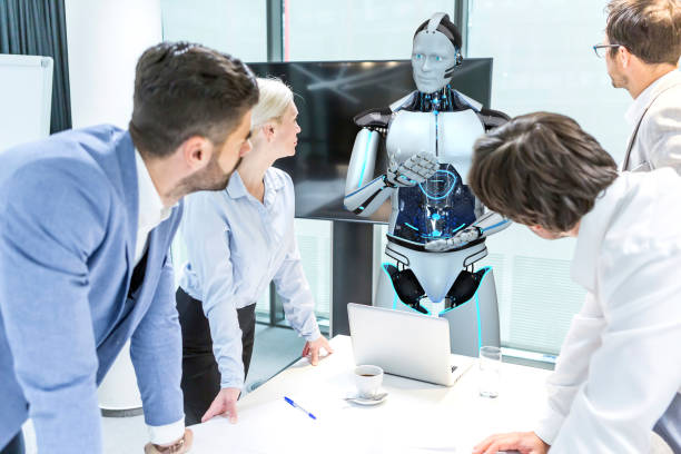 Business meeting with a humanoid robot Business meeting with employees and a humanoid robot. Automated technology groups stock pictures, royalty-free photos & images