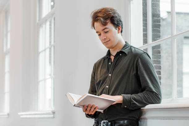 istock Handsome male student in a public library 1365549872