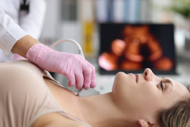 Doctor making ultrasound of thyroid gland to woman patient in clinic Doctor making ultrasound of thyroid gland to woman patient in clinic. Diagnosis and treatment of autoimmune thyroiditis concept thyroid disease stock pictures, royalty-free photos & images