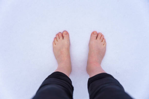 istock Woman stands barefoot in the snow 1365550307