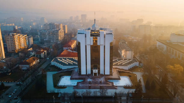 The Presidency building at sunrise in Chisinau, Moldova The Presidency building at sunrise in Chisinau, Moldova. Fog in the air, bare trees, buildings, roads. View from the drone chisinau photos stock pictures, royalty-free photos & images