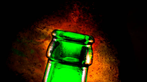 istock Pouring bubbly beer from a green bottle 1365553427