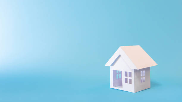istock White house model in blue background for refinance plan and real estate concept. 1365554495