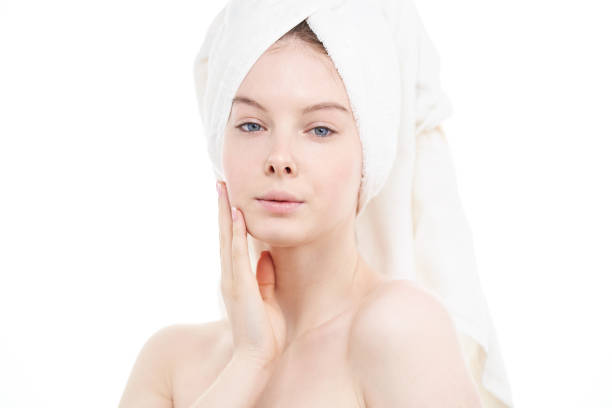 Young woman with perfect clean skin on white background. stock photo