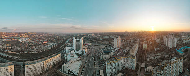 Aerial drone panorama view of Chisinau, Moldova Aerial drone panorama view of Chisinau, Moldova at sunset. Multiple residential and commercial buildings, roads with multiple cars, railroad, bare trees, winter chisinau photos stock pictures, royalty-free photos & images