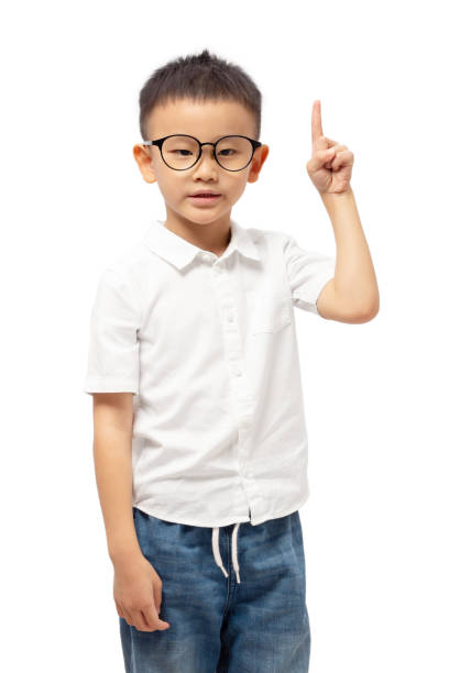 istock Kid with finger pointing up, number one, wearing glasses 1365555588