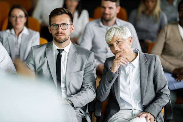 istock Entrepreneurs attending a business seminar in board room. 1365558082