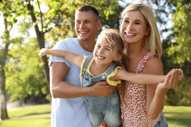 istock Happy parents with their child having fun outdoors. Spending time in nature 1365558266