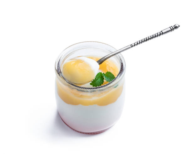istock White creamy yogurt with yellow fruitty puree in small jar isolated on white 1365558932