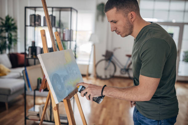 istock Male artists spray painting 1365559758