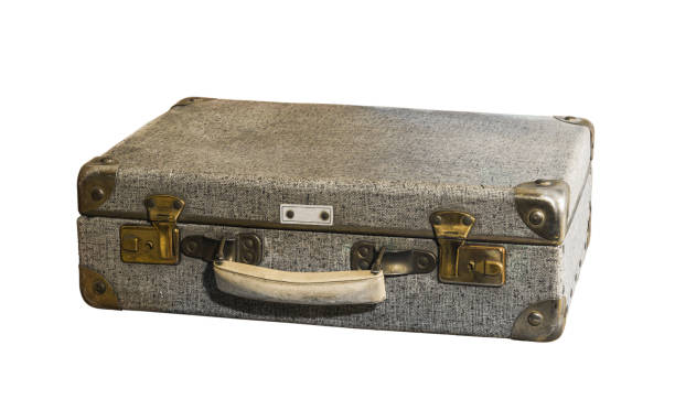 istock A gray, damaged, shabby suitcase with a white handle and metal corners on a white background. Isolated 1365564105