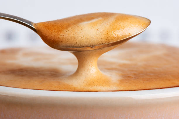 Cup latte coffee with spoon of foam