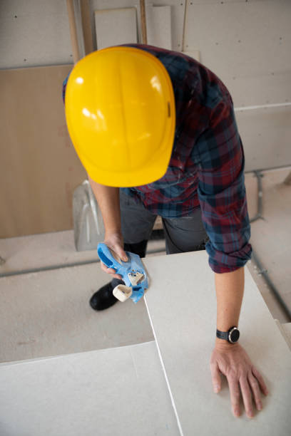 istock drywall worker with yellow safety helmet working on construction site 1365566300