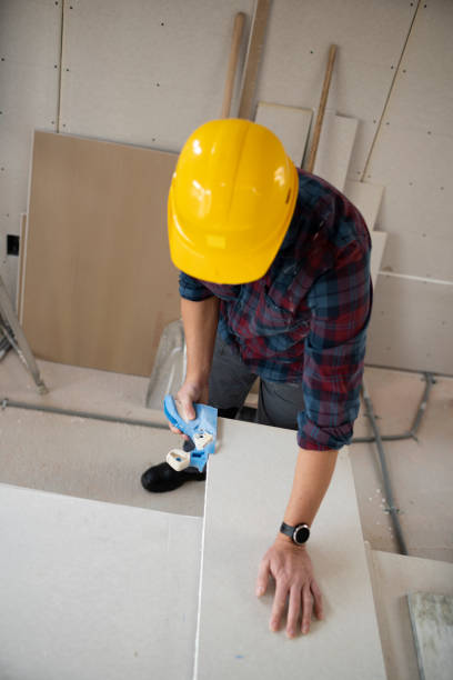 istock drywall worker with yellow safety helmet working on construction site 1365566417