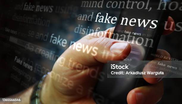 Titles On Screen In Hand With Fake News And Hoax Information 3d Illustration Stock Photo - Download Image Now