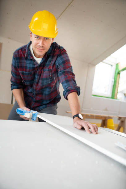 istock drywall worker with yellow safety helmet working on construction site 1365566601