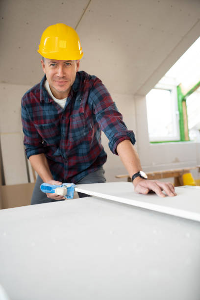 istock drywall worker with yellow safety helmet working on construction site 1365566602