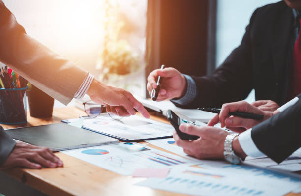 istock Businessmen meeting together, thinking, analyzing projects at the office. 1365567738