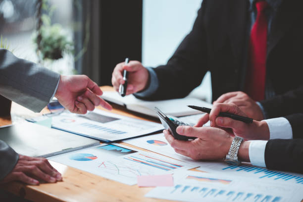 istock Businessmen meeting together, thinking, analyzing projects at the office. 1365567740
